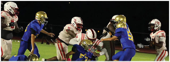 A football player is sliding on the ground. Description generated by AI