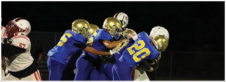 A football player is sliding on the ground. Description generated by AI