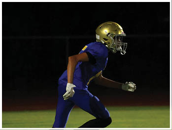 A football player is sliding on the ground. Description generated by AI