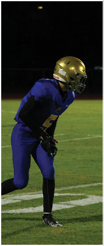 A football player running on the field. Description generated by AI