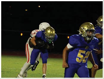A football player is sliding on the ground. Description generated by AI