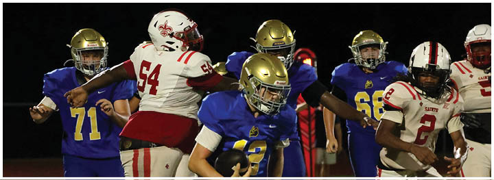 A football player is sliding on the ground. Description generated by AI