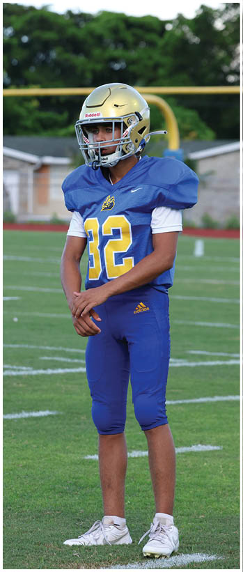 A football player running on the field. Description generated by AI