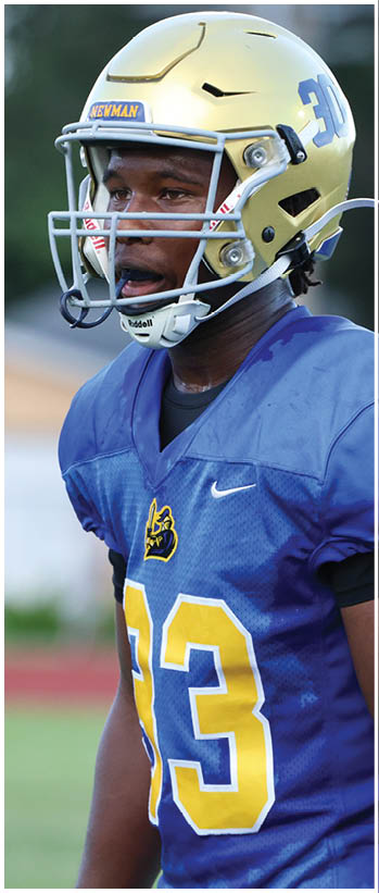 A football player running on the field. Description generated by AI