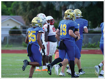 A football player is sliding on the ground. Description generated by AI
