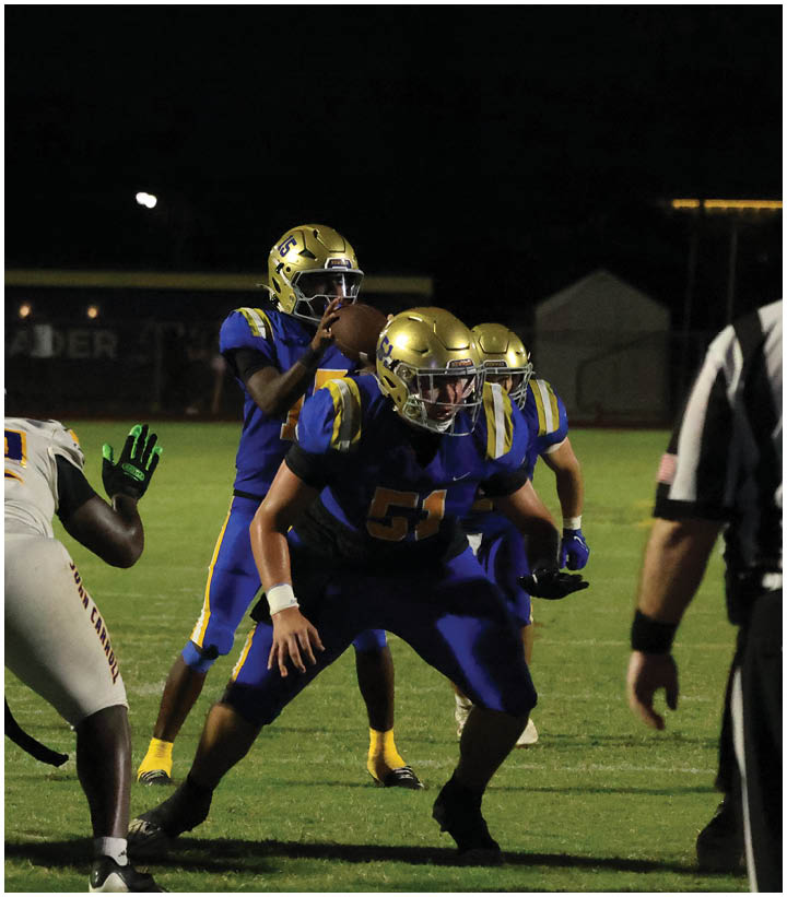 A group of football players wearing black and white uniforms. Description generated by AI