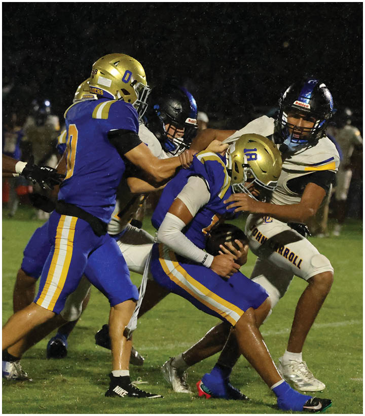 A group of football players wearing black and white uniforms. Description generated by AI