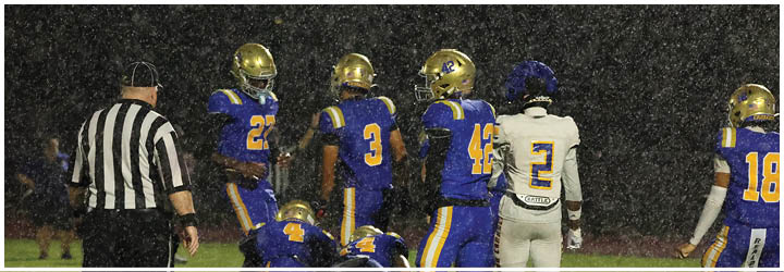 A group of football players on a field. Description generated by AI