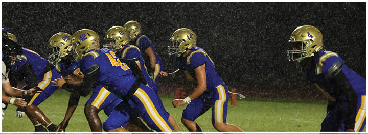 A football player is sliding on the ground. Description generated by AI