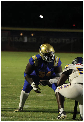 A football player running on the field. Description generated by AI