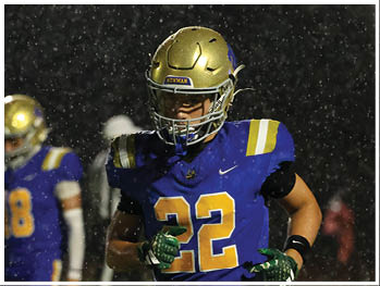 A football player is sliding on the ground. Description generated by AI