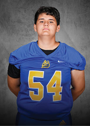 A young man wearing a white and black jersey with the number 14 on it. Description generated by AI