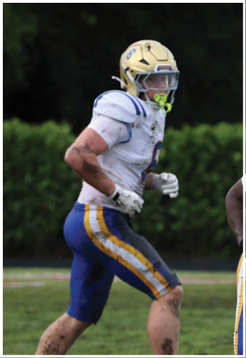 A football player running on the field. Description generated by AI