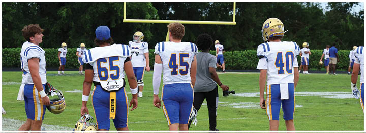 A football player is sliding on the ground. Description generated by AI