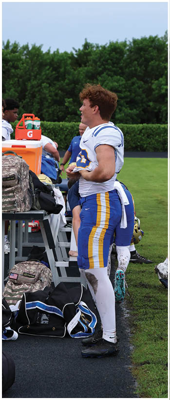 A football player running on the field. Description generated by AI