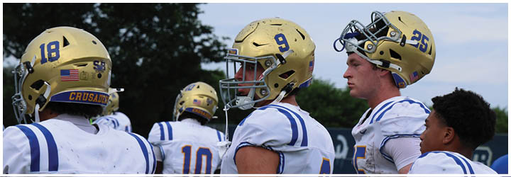 A group of football players on a field. Description generated by AI