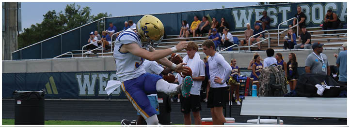 A football player is sliding on the ground. Description generated by AI