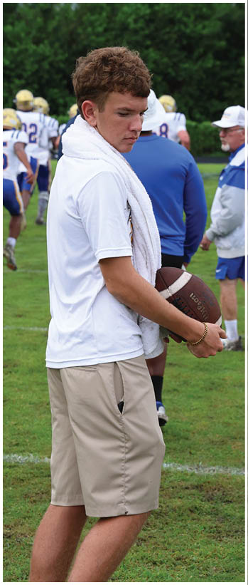 A football player running on the field. Description generated by AI