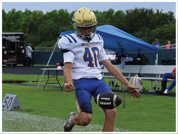 A football player is sliding on the ground. Description generated by AI