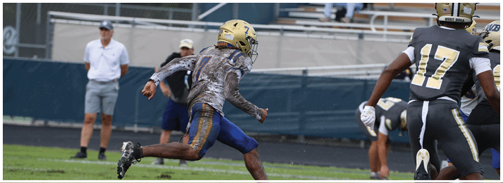 A football player is sliding on the ground. Description generated by AI