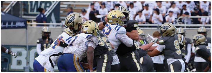 A group of football players on a field. Description generated by AI