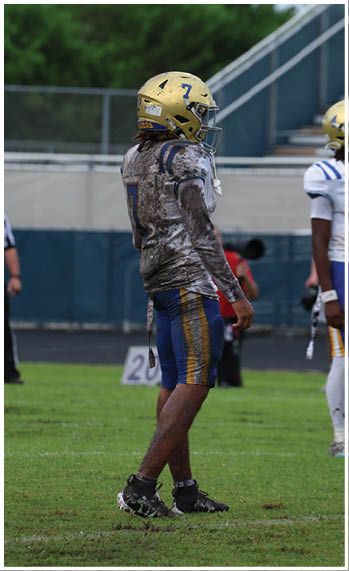 A football player running on the field. Description generated by AI