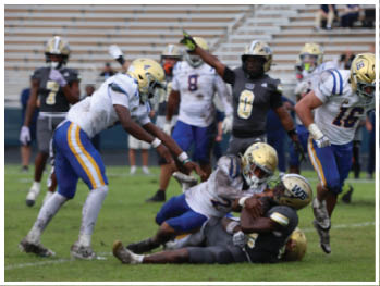 A football player is sliding on the ground. Description generated by AI