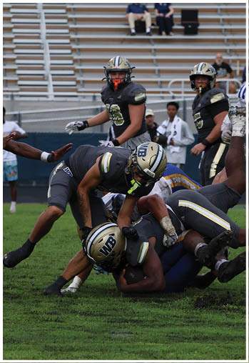 A football player running on the field. Description generated by AI