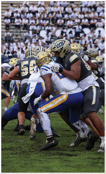 A football player running on the field. Description generated by AI