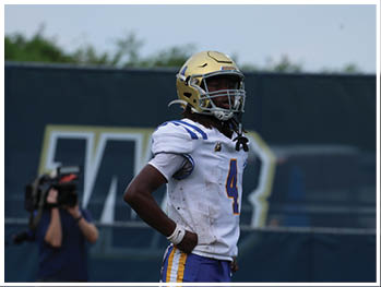 A football player is sliding on the ground. Description generated by AI