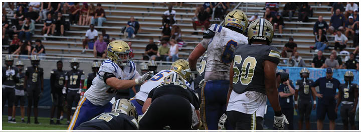 A football player is sliding on the ground. Description generated by AI