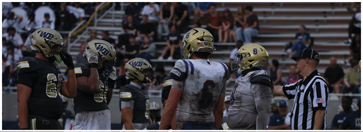 A football player is sliding on the ground. Description generated by AI