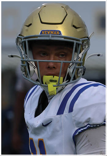 A football player running on the field. Description generated by AI