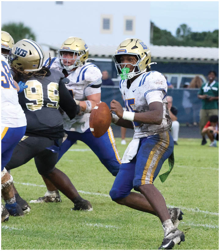 A group of football players wearing black and white uniforms. Description generated by AI