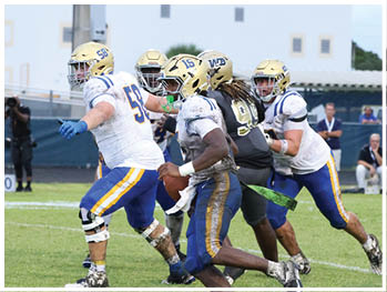 A football player is sliding on the ground. Description generated by AI