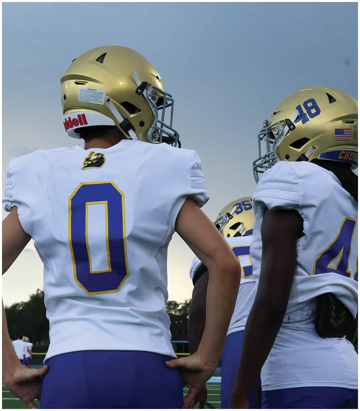 A group of football players wearing black and white uniforms. Description generated by AI