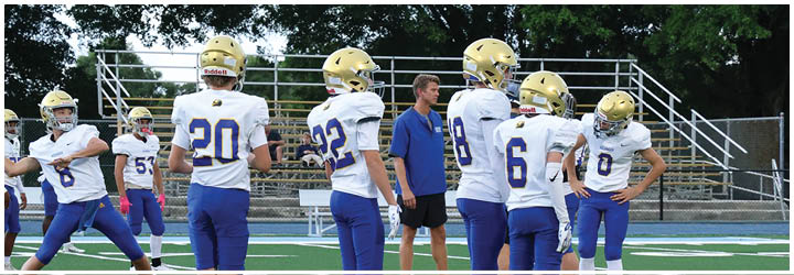 A group of football players on a field. Description generated by AI