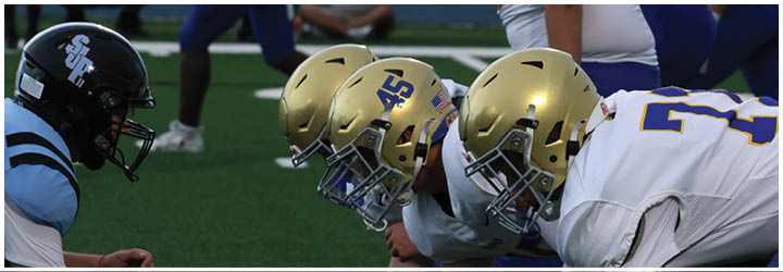 A group of football players on a field. Description generated by AI