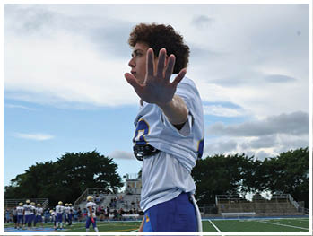 A football player is sliding on the ground. Description generated by AI