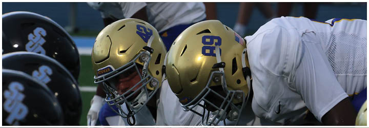 A group of football players on a field. Description generated by AI
