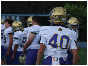 A football player is sliding on the ground. Description generated by AI