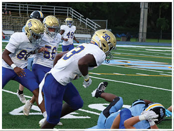 A football player is sliding on the ground. Description generated by AI