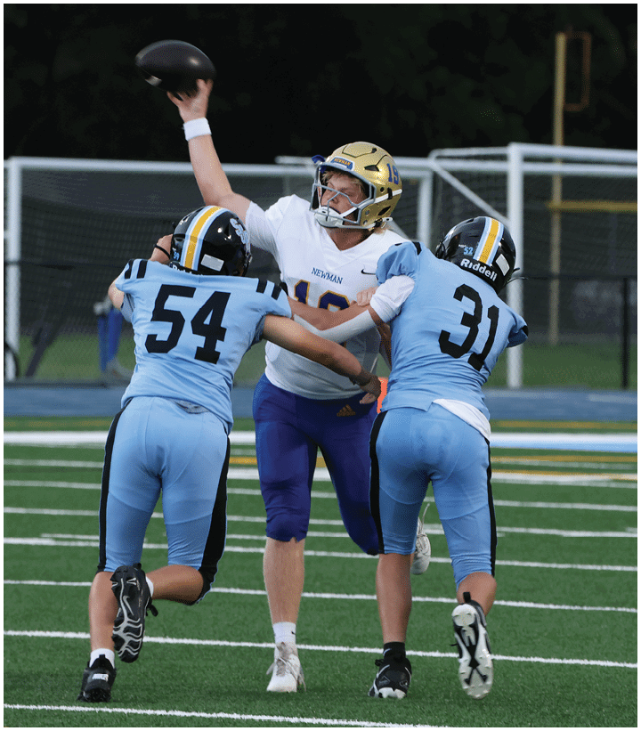 A group of football players wearing black and white uniforms. Description generated by AI