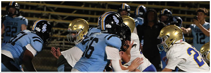 A group of football players on a field. Description generated by AI