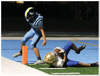 A football player is sliding on the ground. Description generated by AI