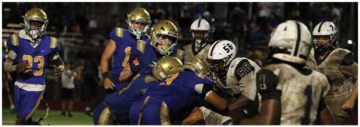 A football player is sliding on the ground. Description generated by AI
