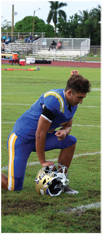 A football player running on the field. Description generated by AI