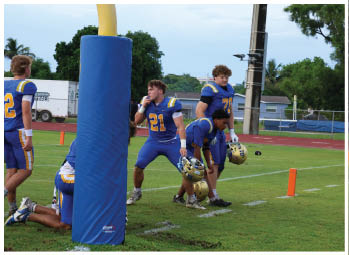 A football player is sliding on the ground. Description generated by AI