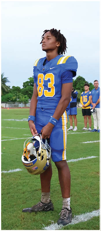 A football player running on the field. Description generated by AI