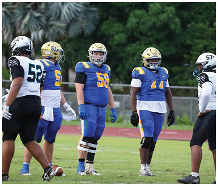 A football player wearing a blue and white uniform. Description generated by AI